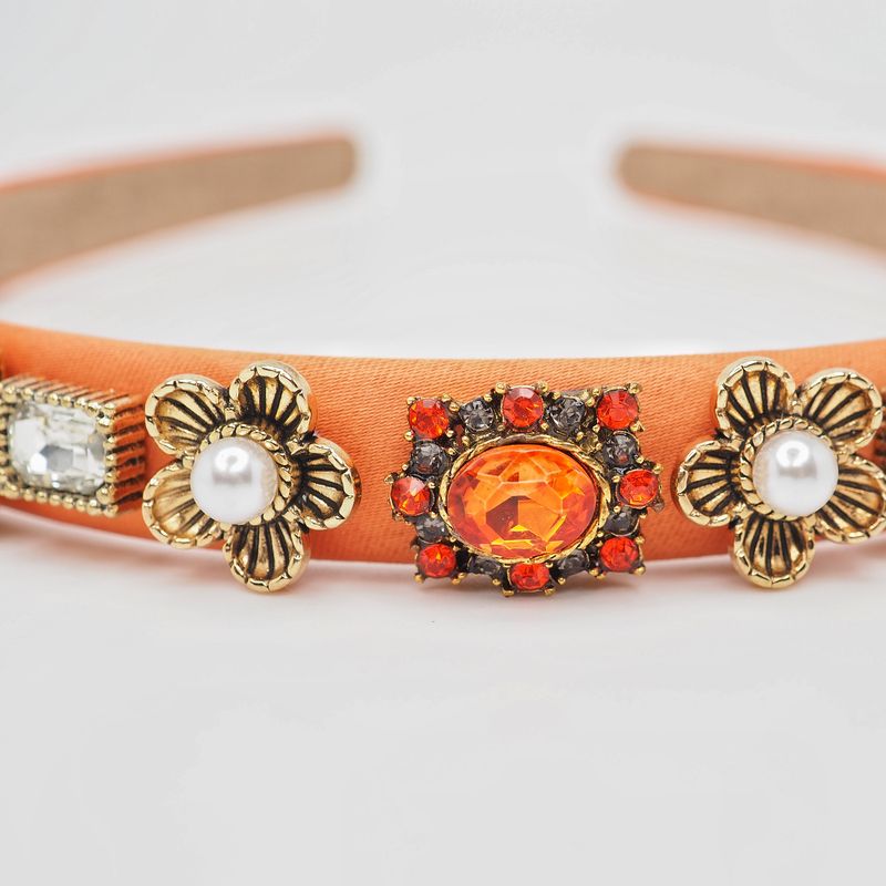 Hårbøyle med perle- og steinerblomster orange